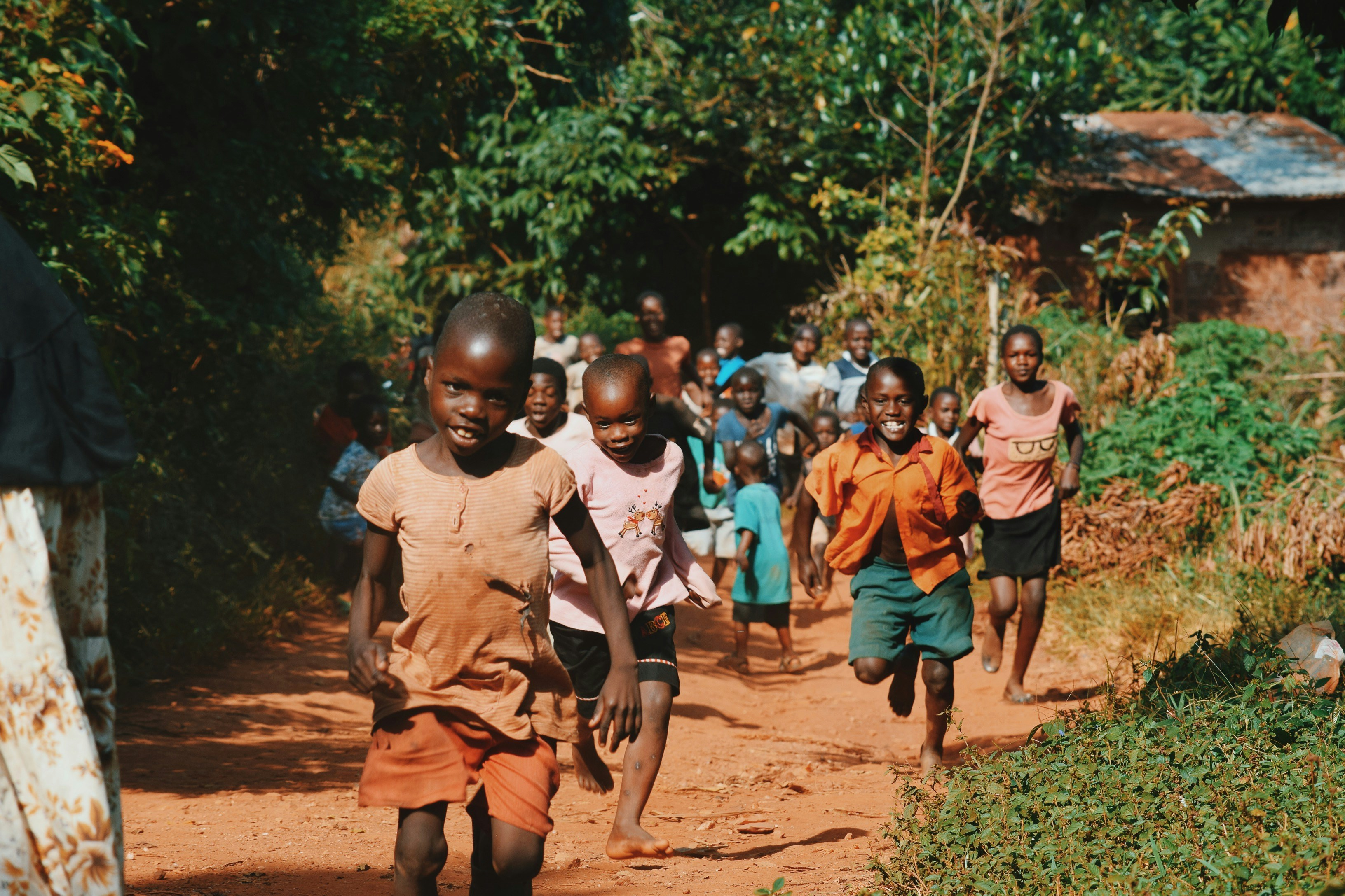 Ugandan children running through their community